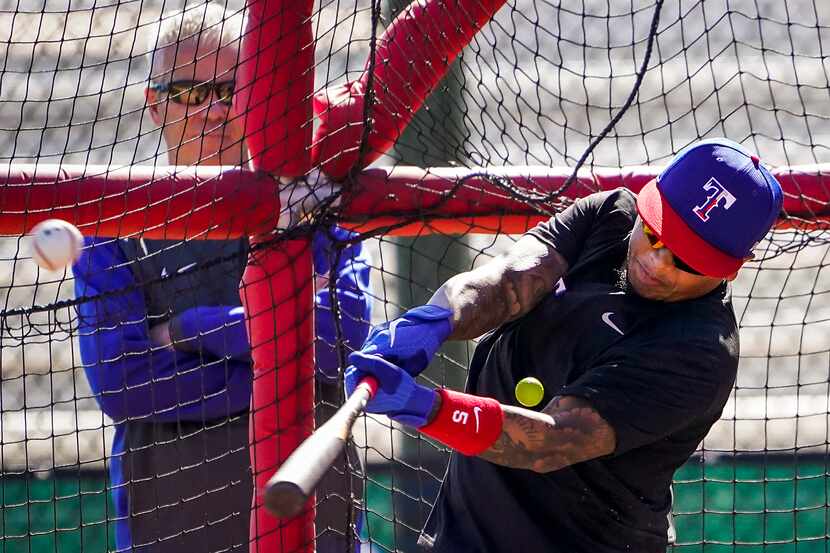 Texas Rangers outfielder Willie Calhoun takes batting practice during a spring training...