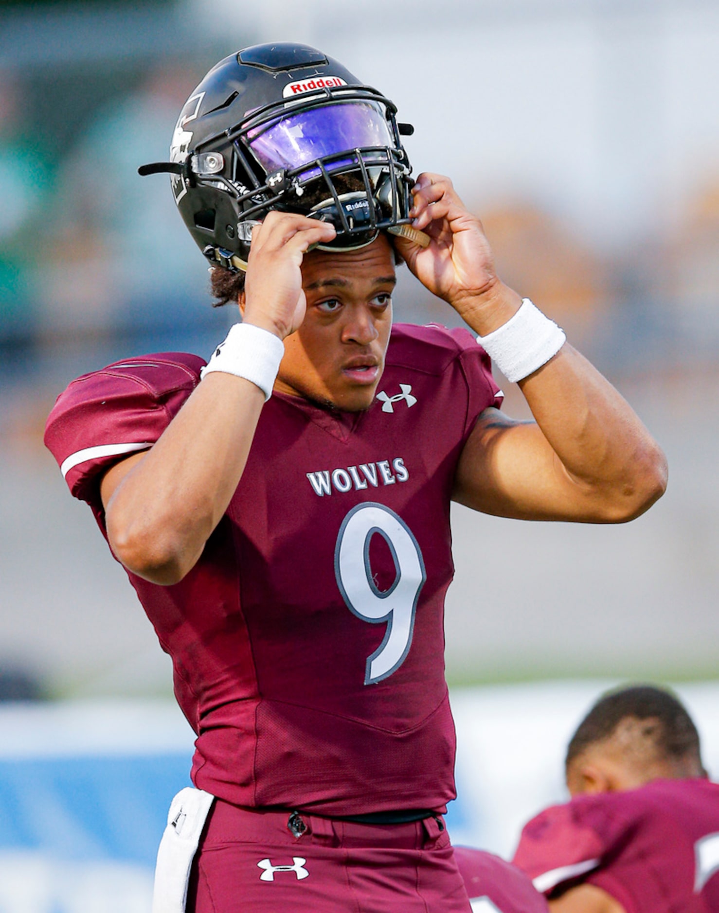 TXHSFB Mansfield Timberview senior quarterback Jaden Hullaby (9) puts on his helmet before...