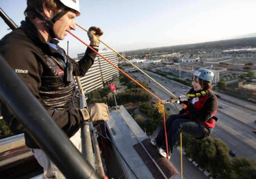 Trevor Deighton of Over the Edge guided Anna deHaro of Clear Channel Radio DFW off the edge...