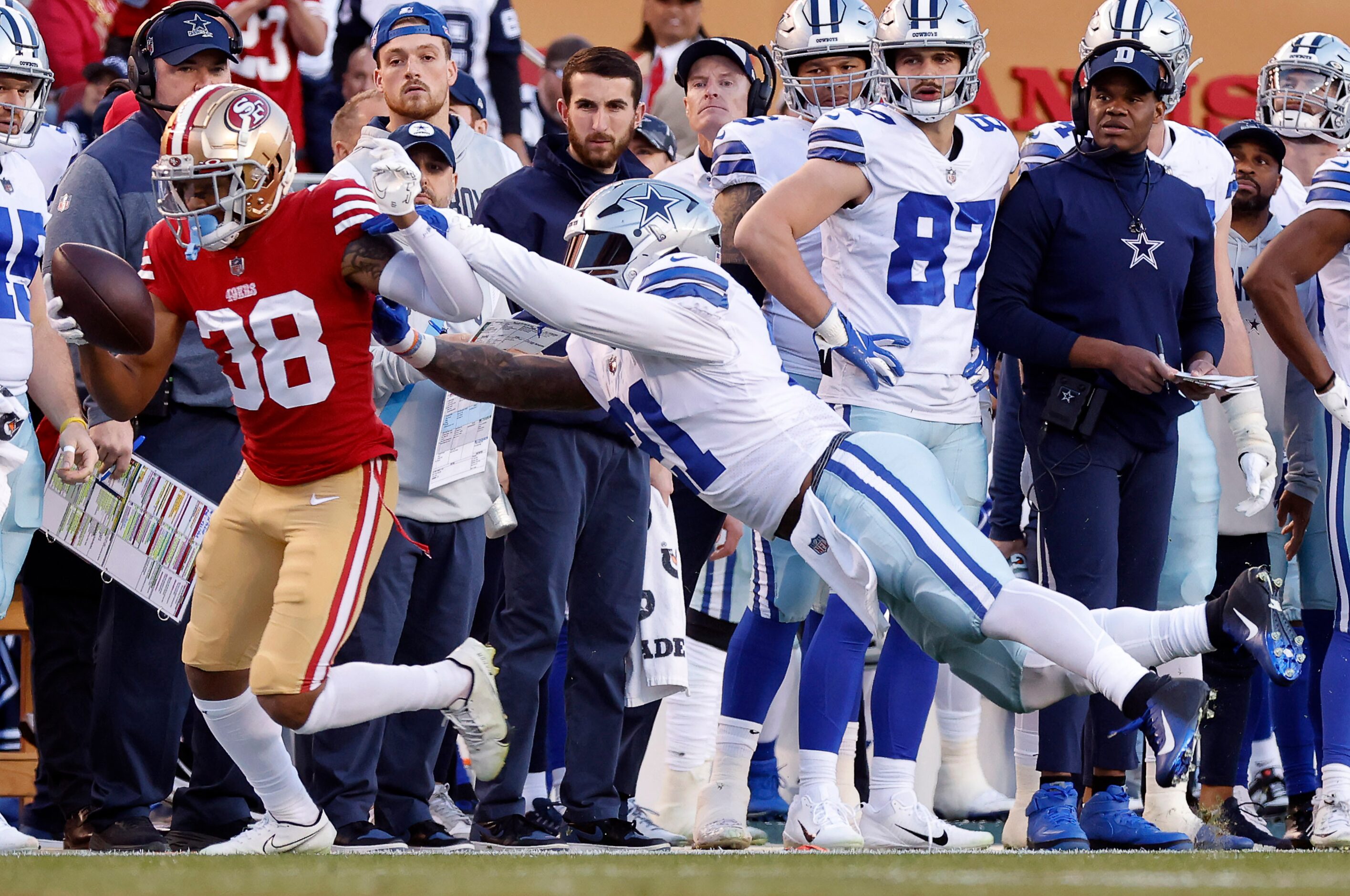 Dallas Cowboys running back Ezekiel Elliott (21) pushes San Francisco 49ers cornerback...