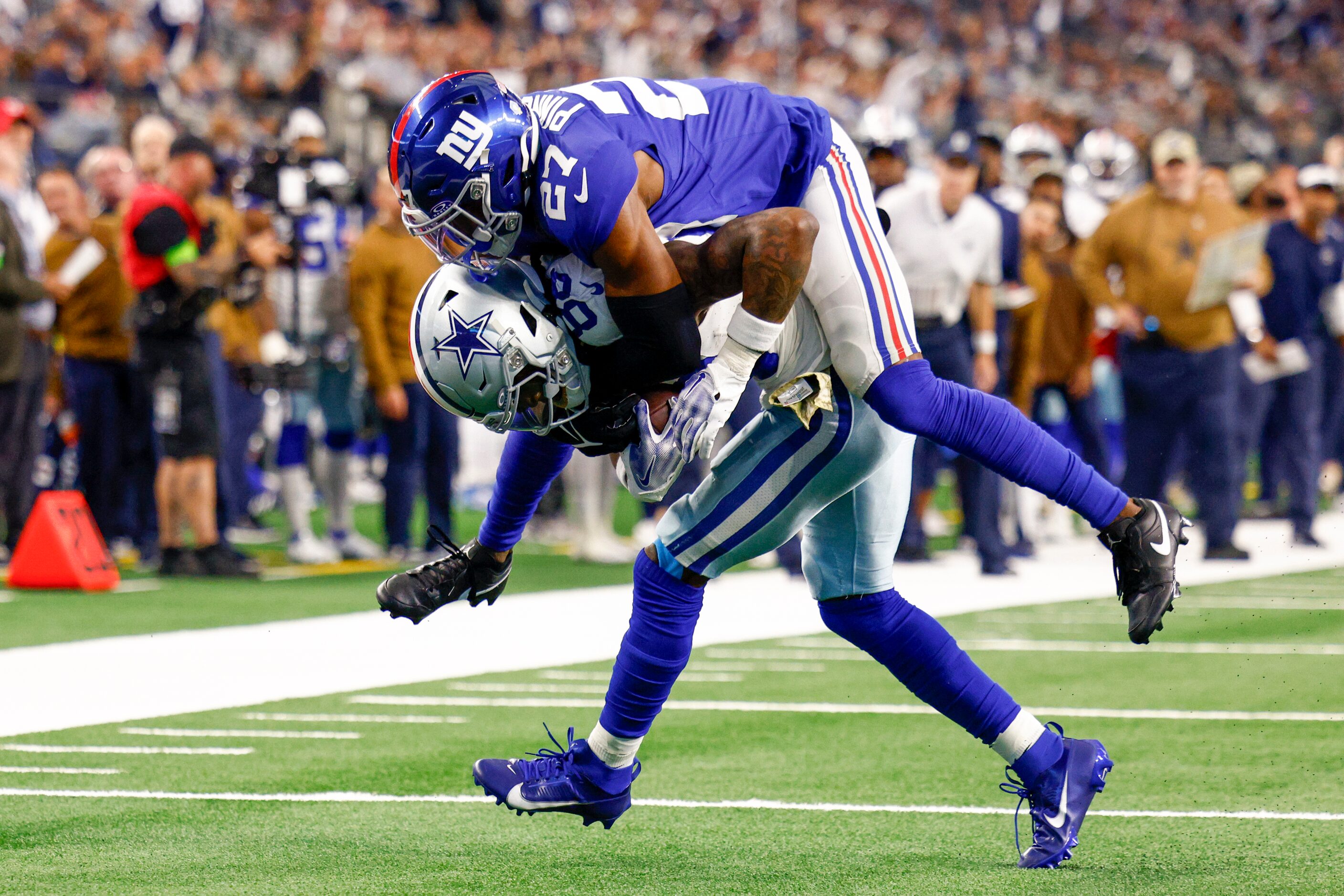 New York Giants safety Jason Pinnock (27) jumps on Dallas Cowboys wide receiver CeeDee Lamb...