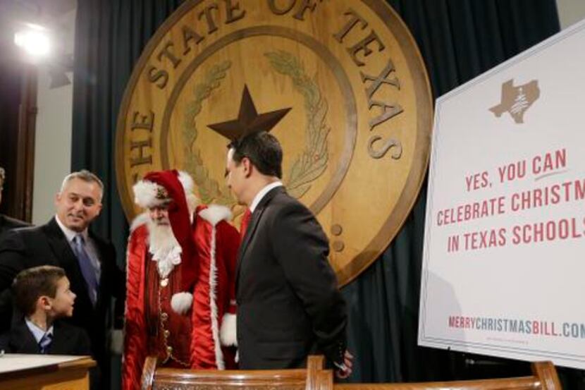
Bill French, dressed as Santa Claus, takes part in a news conference at the state capitol...