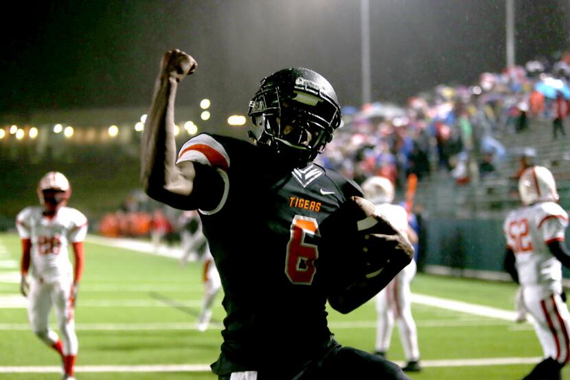 Lancaster’s Rickey Henderson (6) celebrates his touchdown against Terrell, during game...