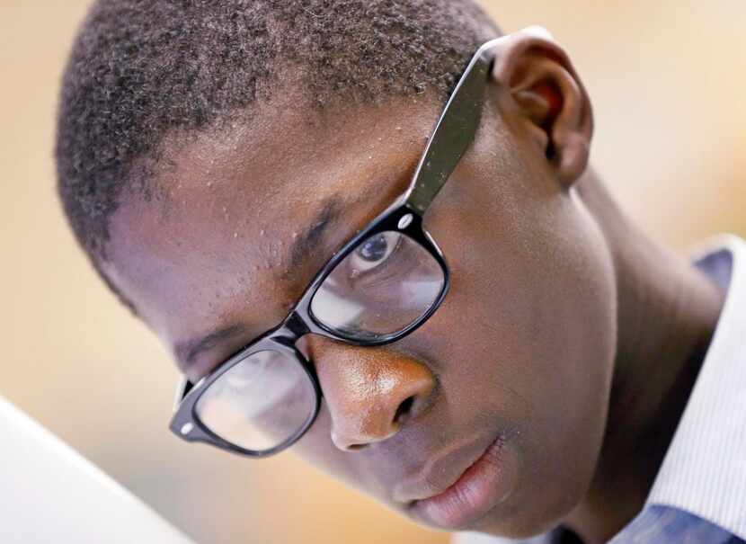 
Lee Kamara eyes the paper while he takes his exam during his 7th grade science class at...