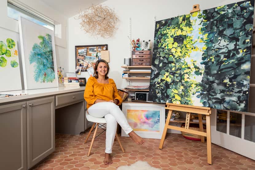 Artist Brenda Ciardiello sits in her studio, surrounded by her art.