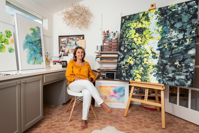 Artist Brenda Ciardiello sits in her studio, surrounded by her art.