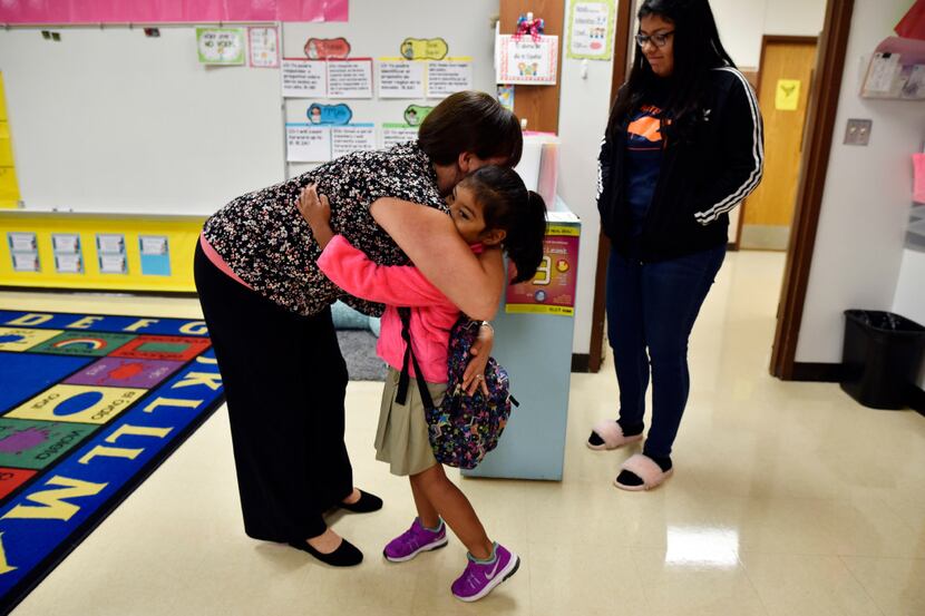 Bilingual kindergarten teacher Carmen Sanchez greeted 5-year-old Ailyn Espinoza as the girl...