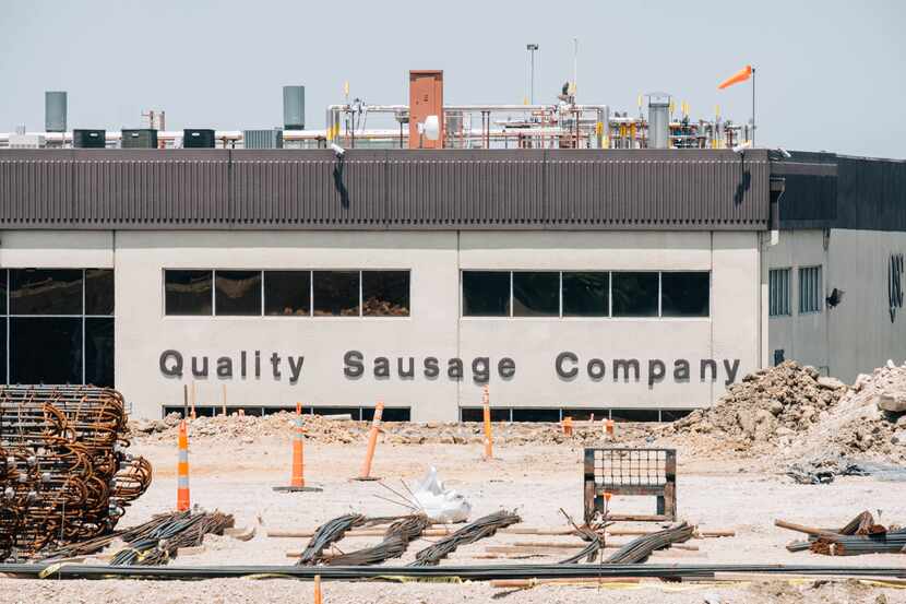 The Quality Sausage Company in Dallas, Texas, partially obstructed by an ongoing...