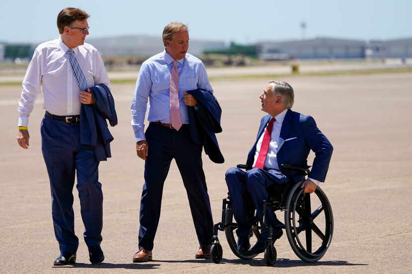 Texas Lt. Gov. Dan Patrick, Attorney General Ken Paxton and Gov. Greg Abbott await the...