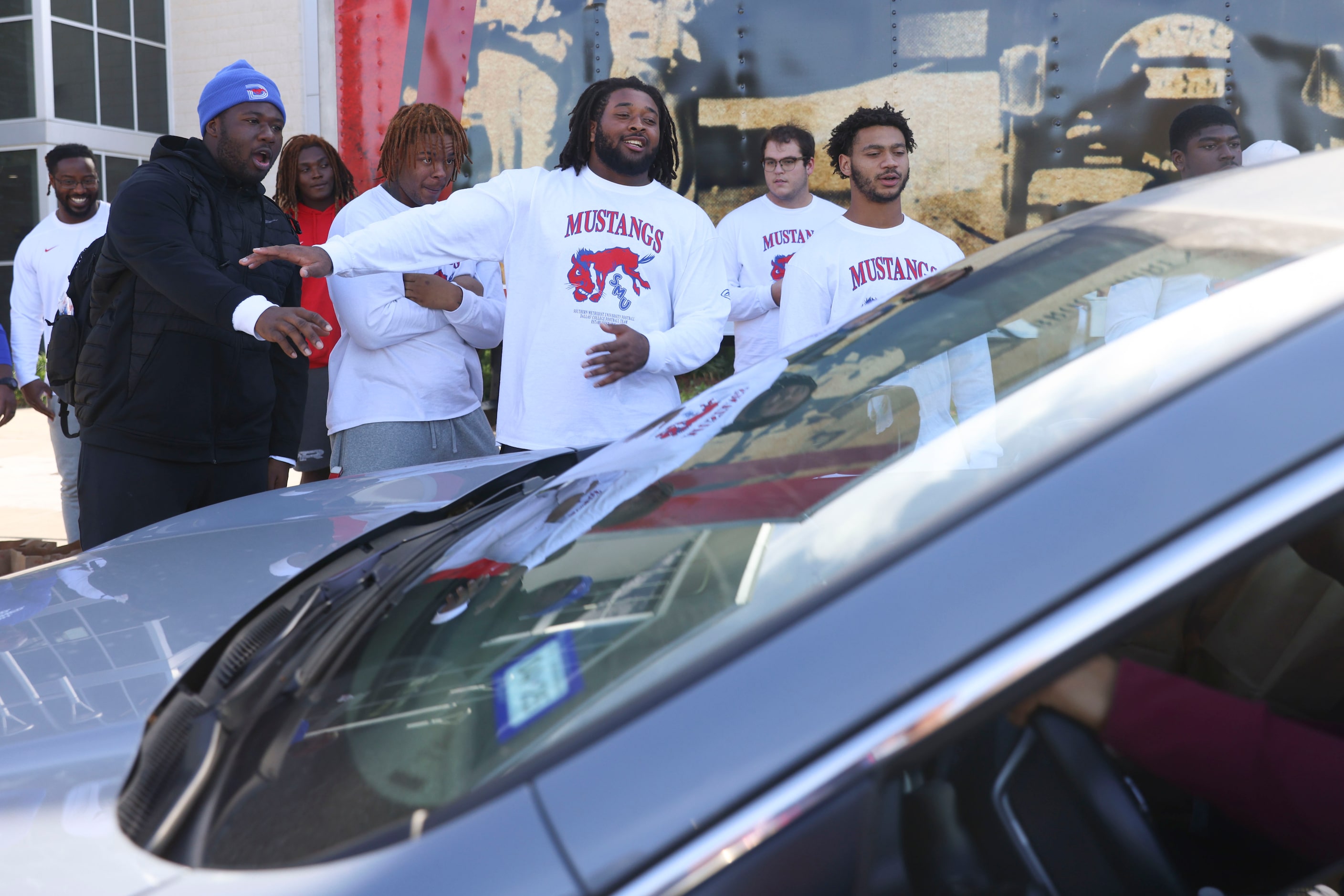 Southern Methodist University Alex Woods (center) and his teammates direct traffic during a...