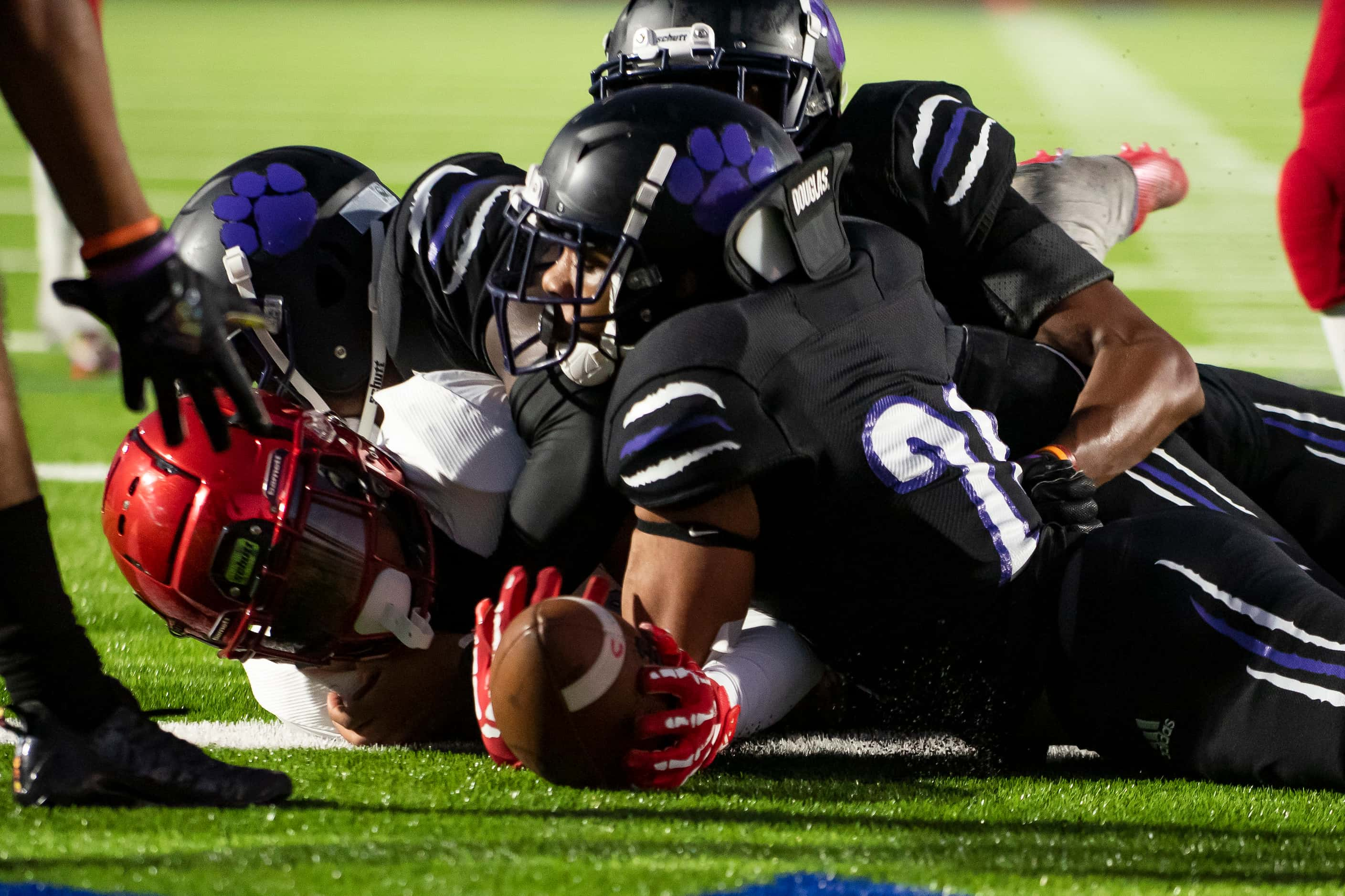 Carter junior Kaeden Landry (24) stretches across the goal line to score a touchdown in the...