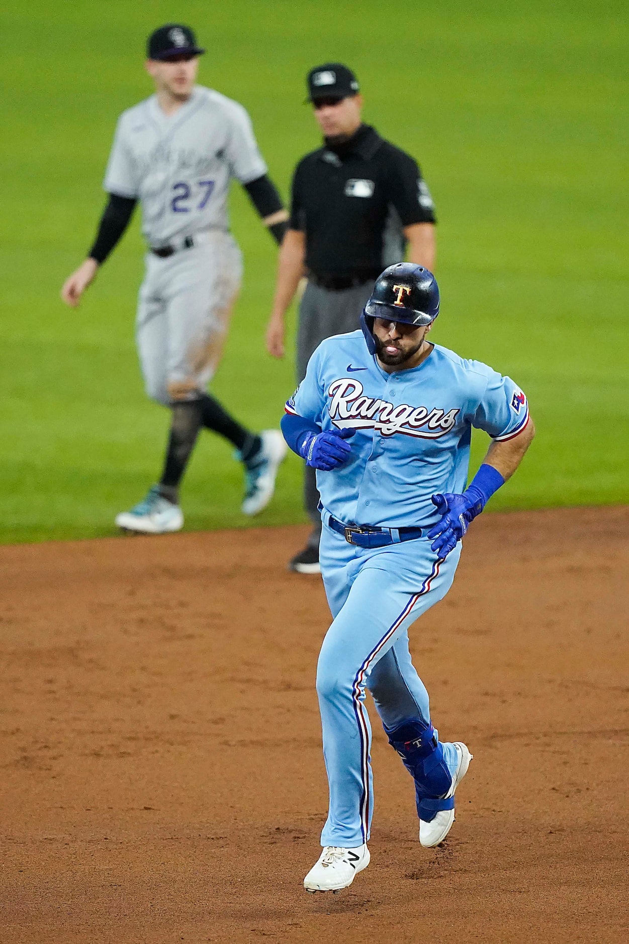 Texas Rangers outfielder Joey Gallo rounds the bases after hitting the first official home...