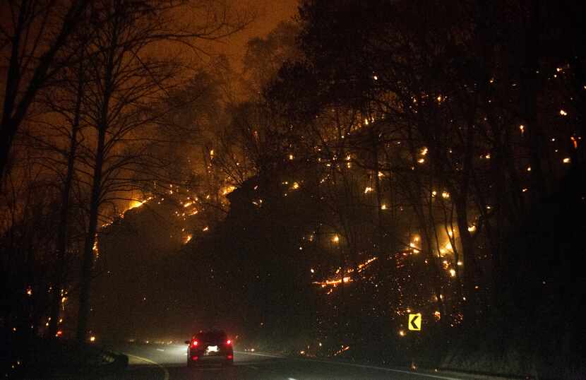 Fire erupts on both side of Highway 441 between Gatlinburg and Pigeon Forge, Tenn., Monday,...