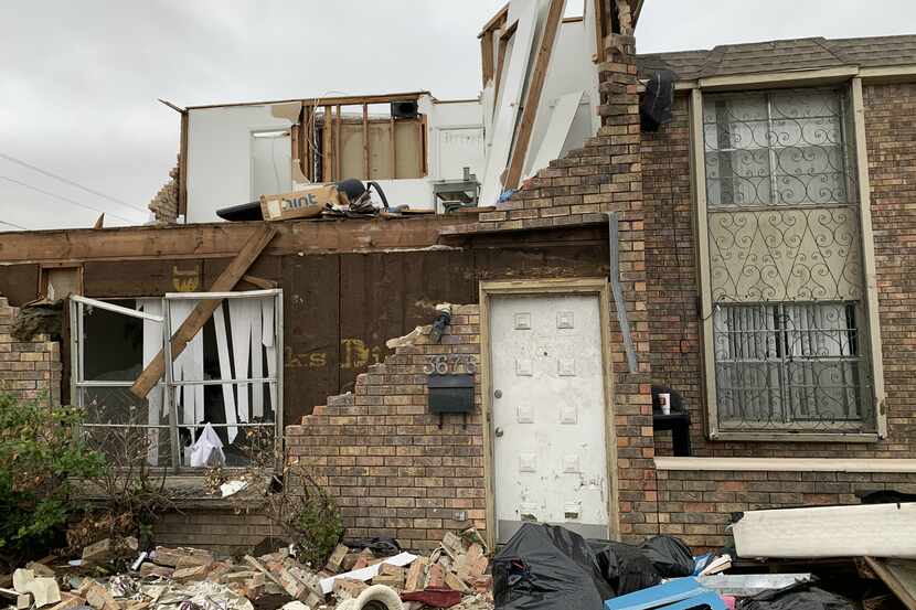This view, of a someone's home office in tatters after the tornado, can still be seen as...