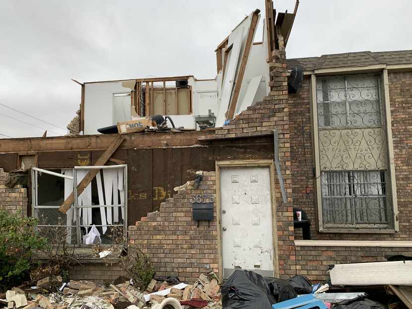 This view, of someone's home office in tatters after the tornado, can still be seen as...