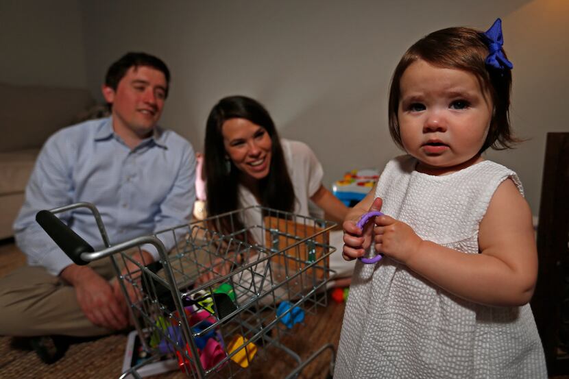 Leigh and Austin Winans watch their 1-year-old daughter Ellie Grace Winans at their home in...