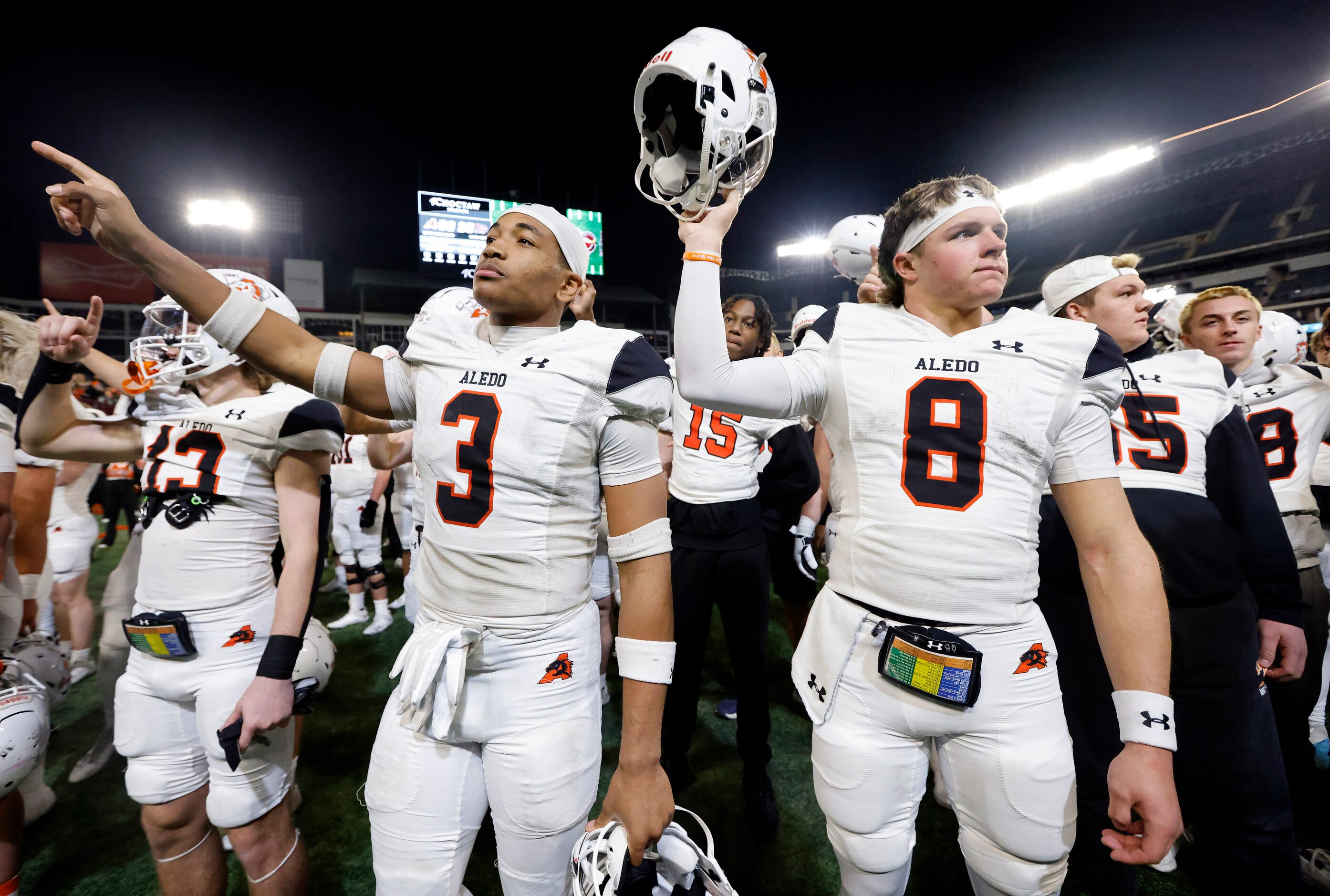 Aledo quarterback Hauss Hejny (8) and linebacker Davhon Keys (3) join the band in the school...