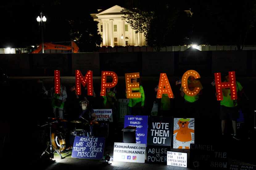 Protesters with "Kremlin Annex" call to impeach President Donald Trump in Lafayette Square...