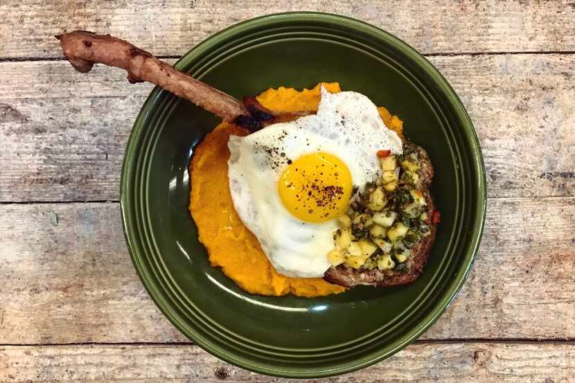 A fried egg, sweet potato mash and beer-brined pork chop is on the menu at Mudhen Meat and...