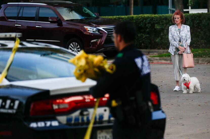 A bystander watches as Dallas police wrap up at a crime scene where two children and two...