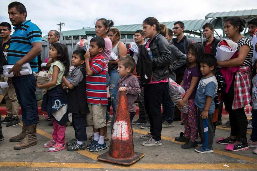 Unauthorized immigrants arrive at a bus station in McAllen after they were processed and...