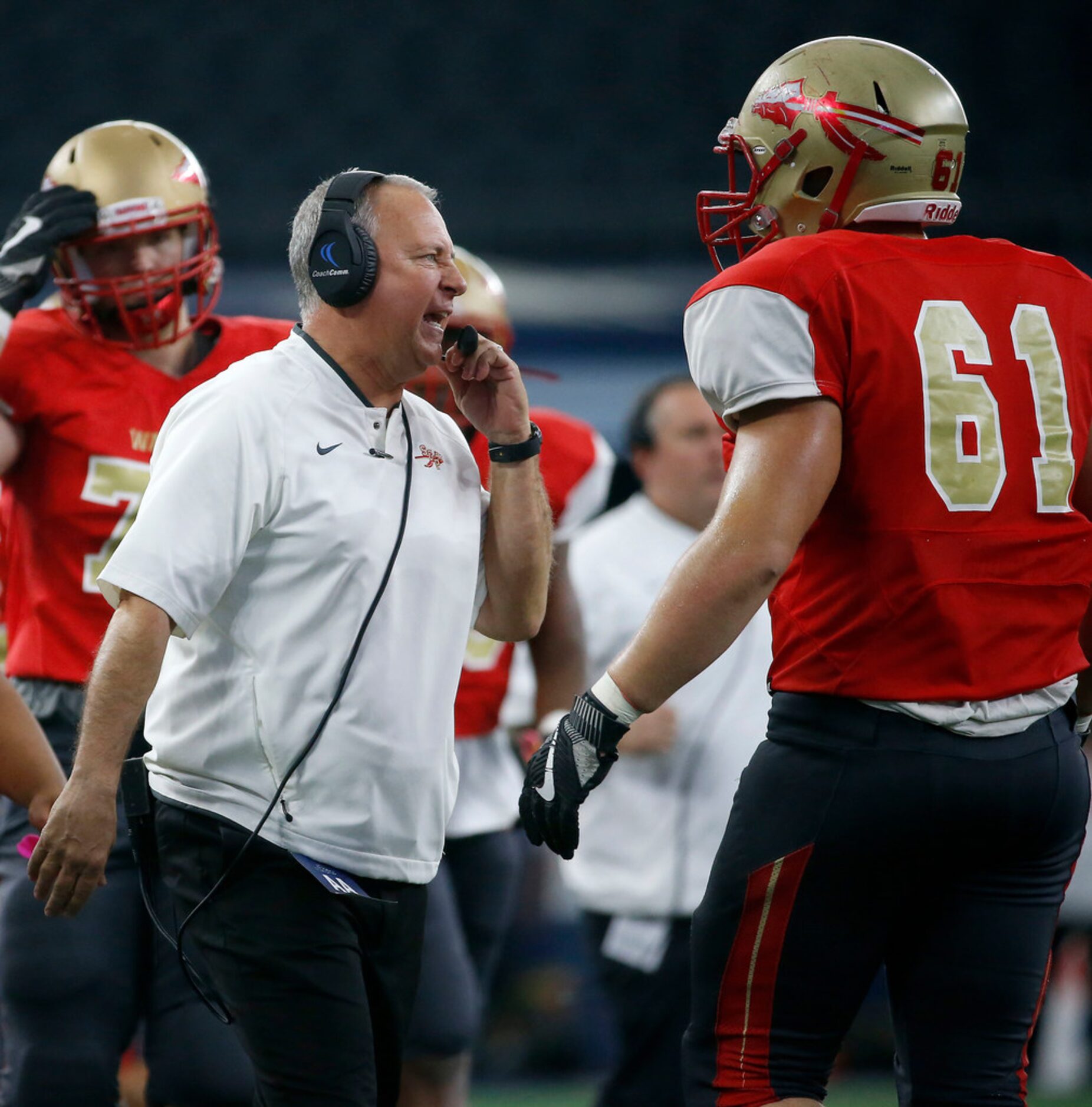 South Grand Prairie head coach Brent Whitson (left) talks with his players including Blade...