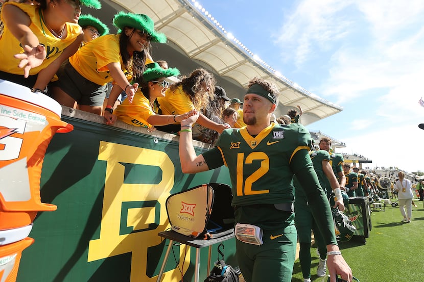 Baylor quarterback Blake Shapen greets the student section after defeating Kansas in an NCAA...