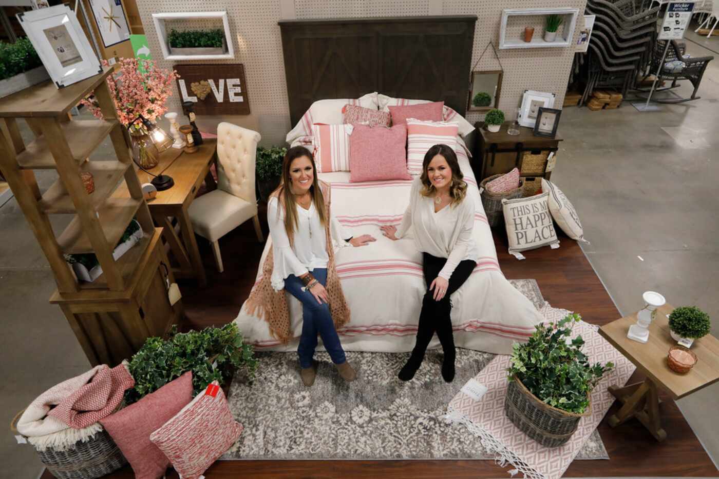 Ashley Turner (left) and Whitney Gainer pose in one of their displays at At Home. The...