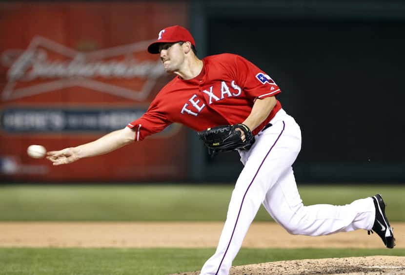 FILE - Texas Rangers relief pitcher Darren O'Day (56) throw a sidearm pitch during eighth...
