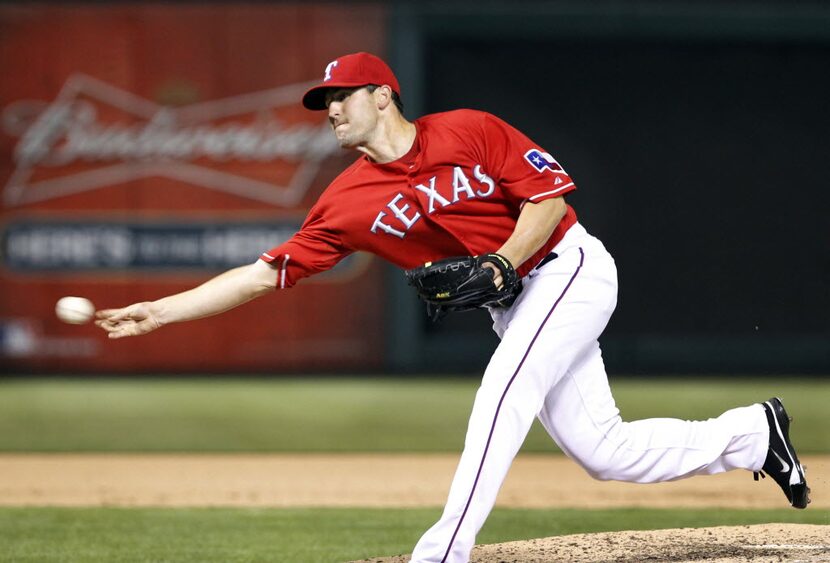 FILE - Texas Rangers relief pitcher Darren O'Day (56) throw a sidearm pitch during eighth...