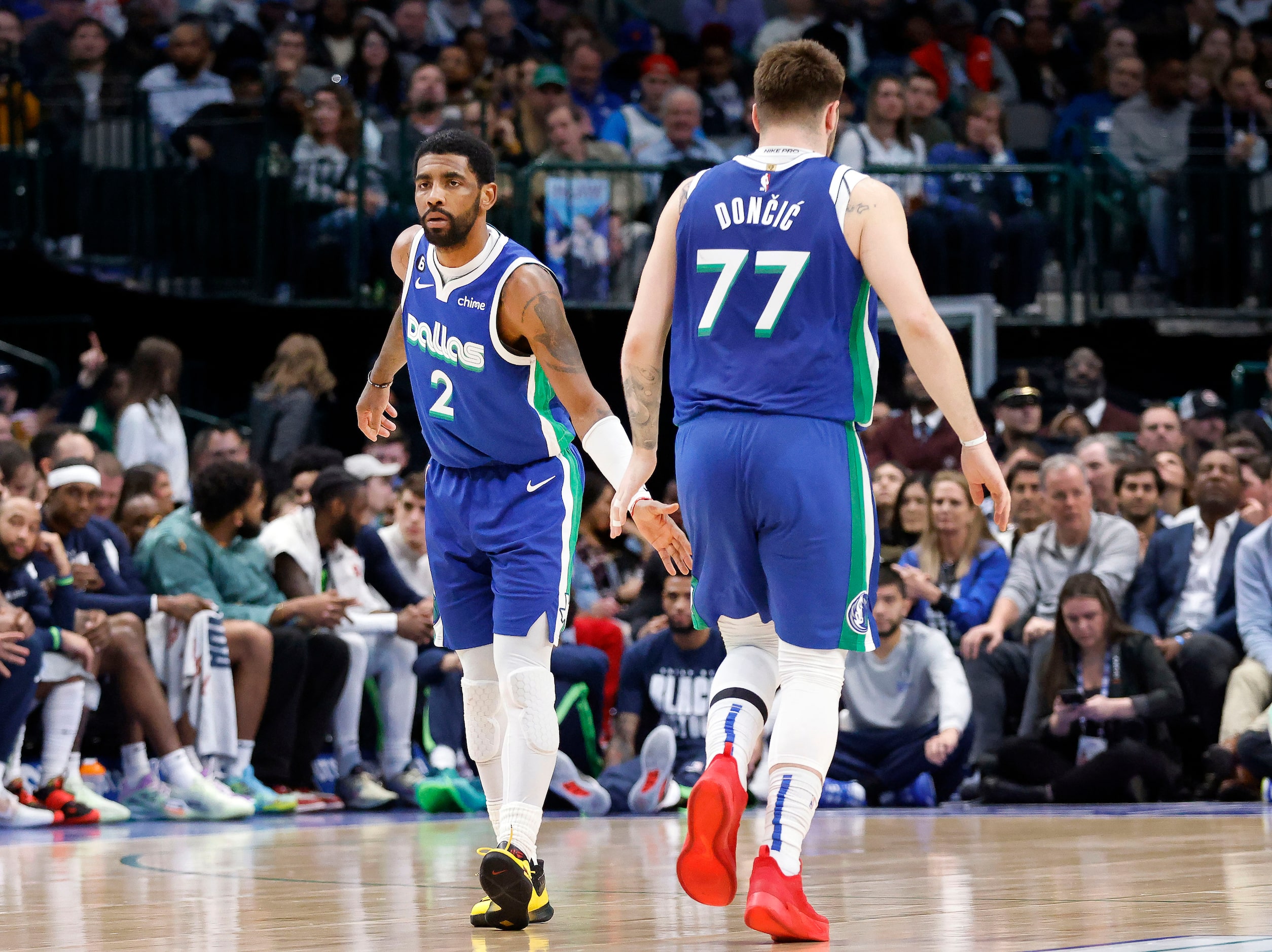 Dallas Mavericks guards Kyrie Irving (2) and Luka Doncic (77) slap hands following a second...