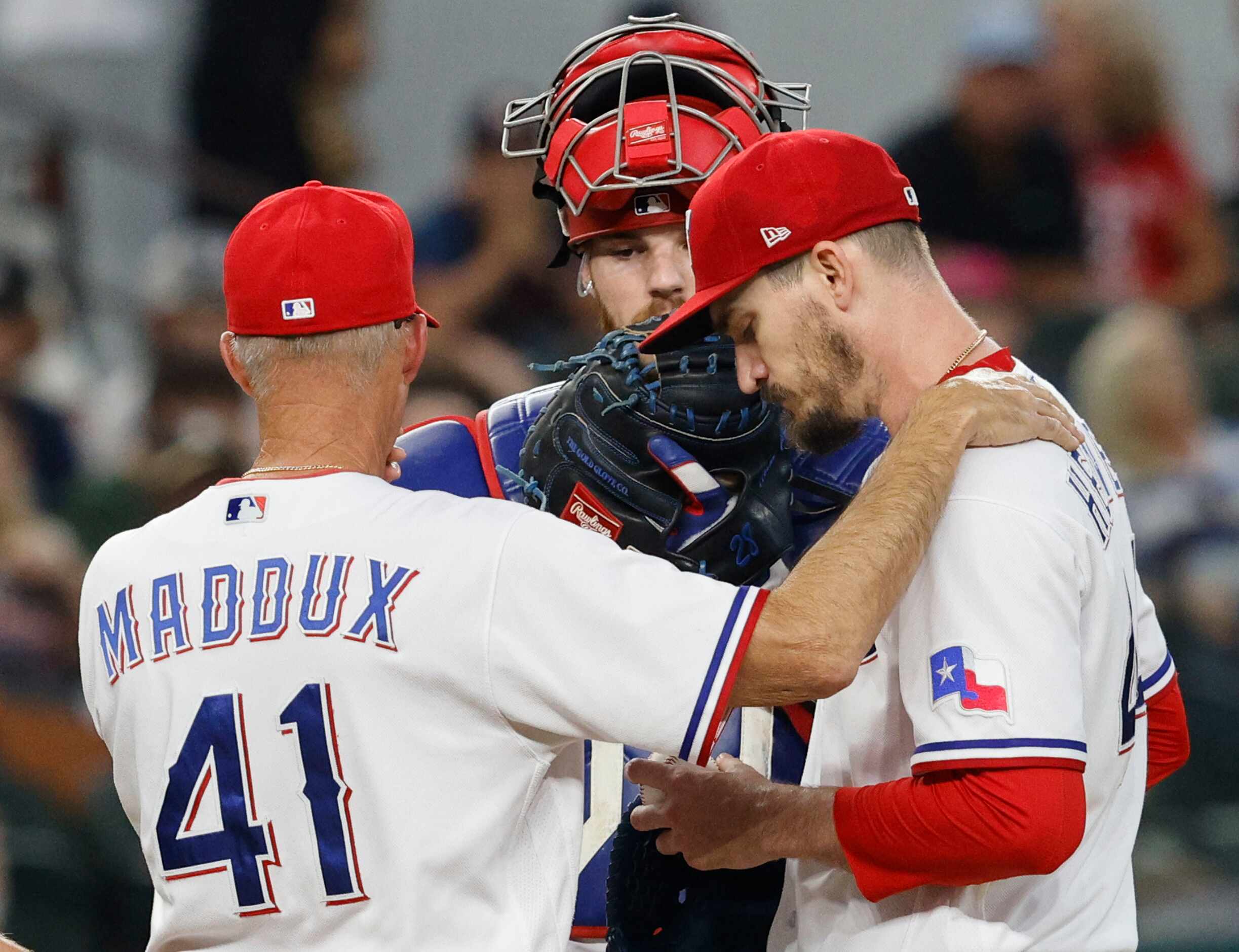 Texas Rangers pitching coach Mike Maddox (41) talks with Texas Rangers starting pitcher...