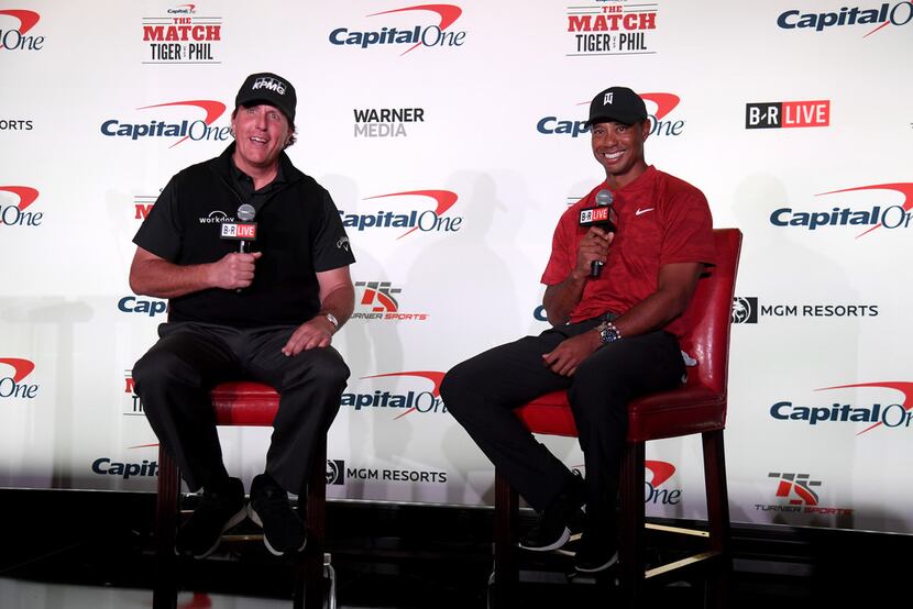 Phil Mickelson and Tiger Woods speak with the media during a press conference before The...