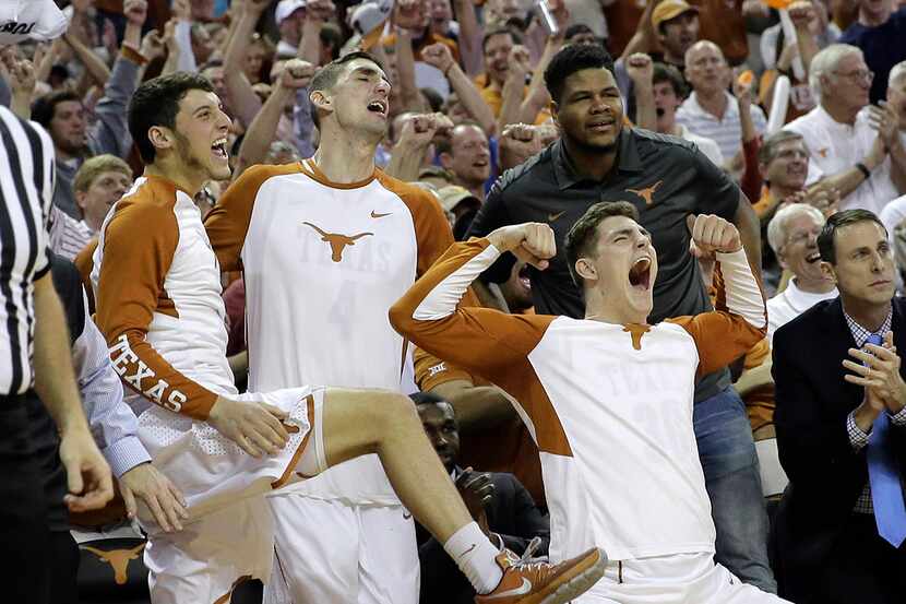 Texas forward Ryan McClurg (30) and teammates celebrate from the bench during the second...