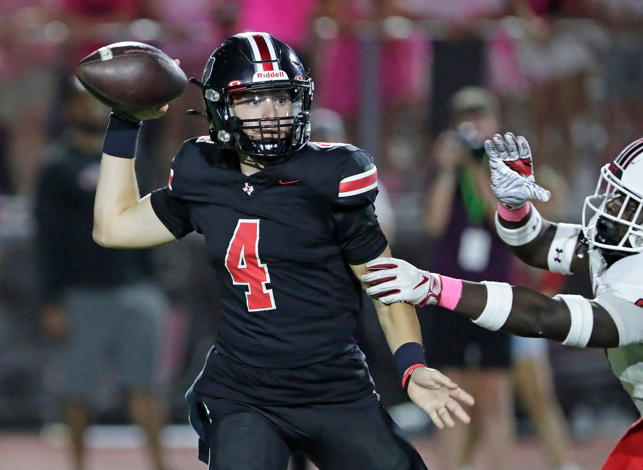 Lovejoy High School quarterback Jacob Janecek (4) is hurried on a pass during the first half...