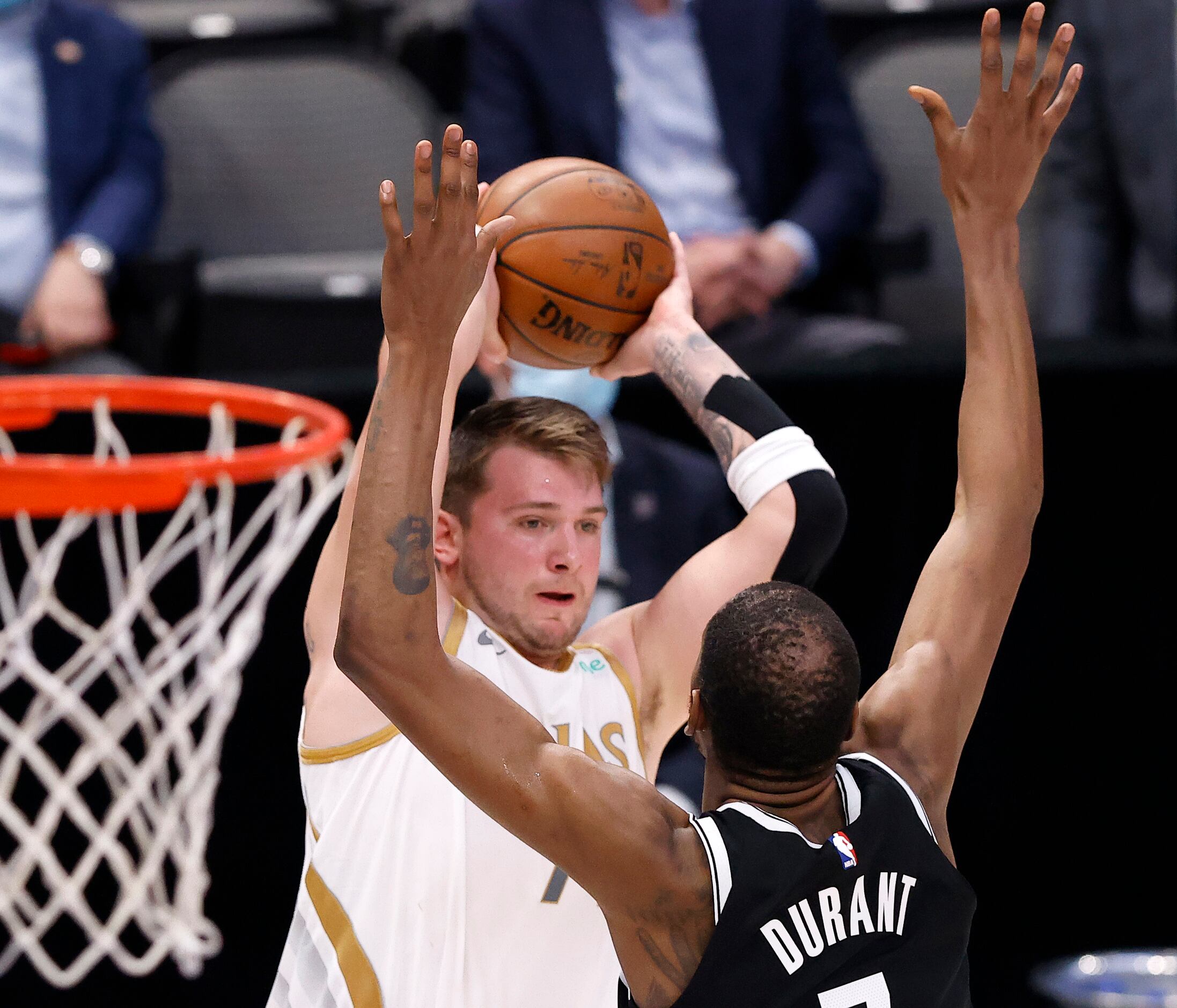 Dallas Mavericks guard Luka Doncic (77) passes over Brooklyn Nets forward Kevin Durant (7)...