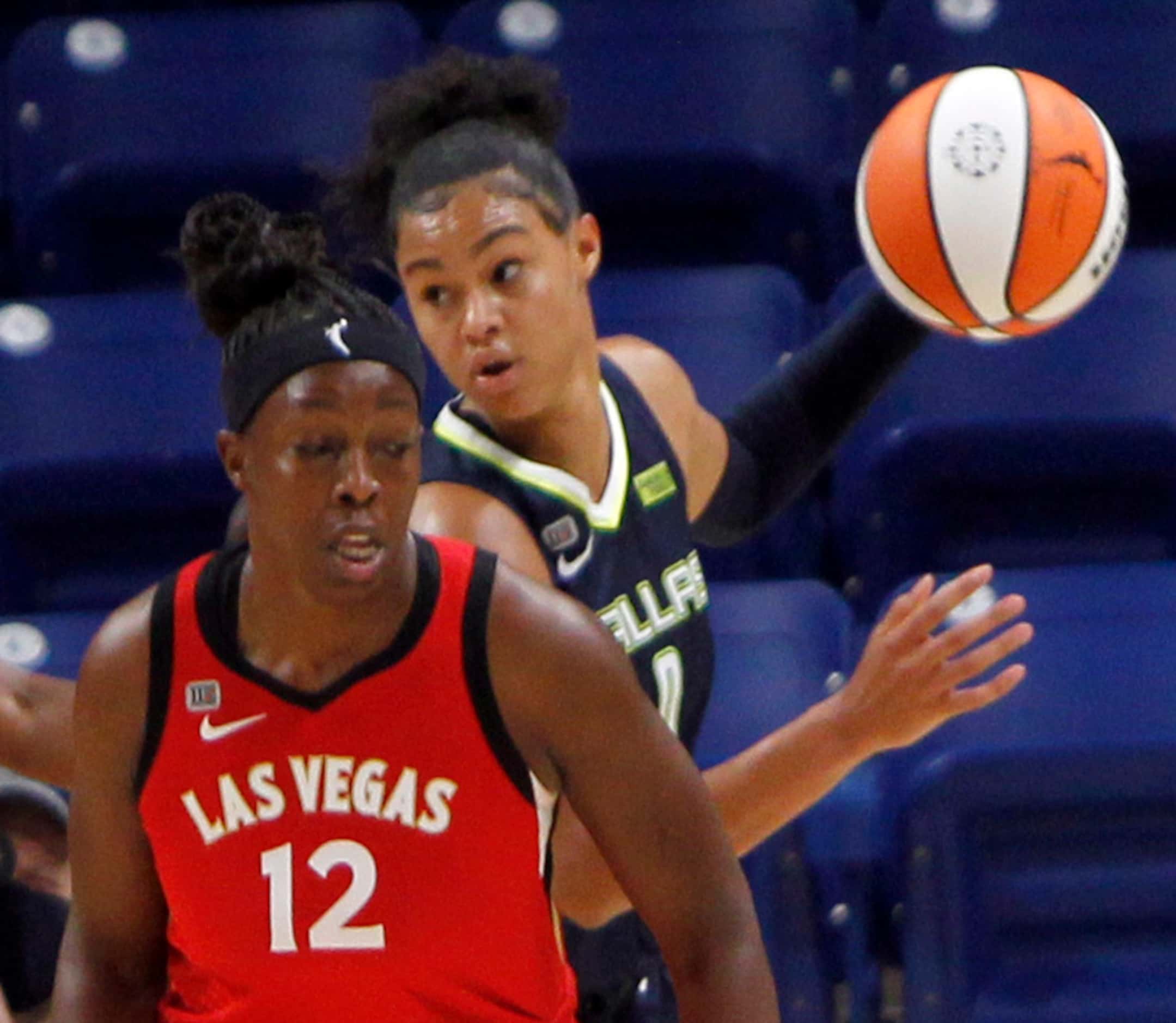 Dallas Wings forward Satou Sabally (0) looks to pass after slipping behind the defense of...