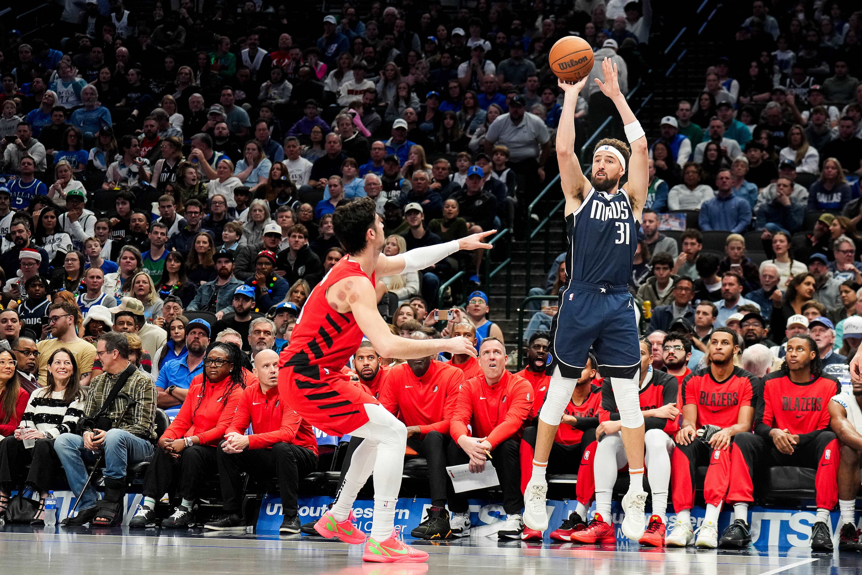 Dallas Mavericks guard Klay Thompson (31) shoots over Portland Trail Blazers forward Deni...