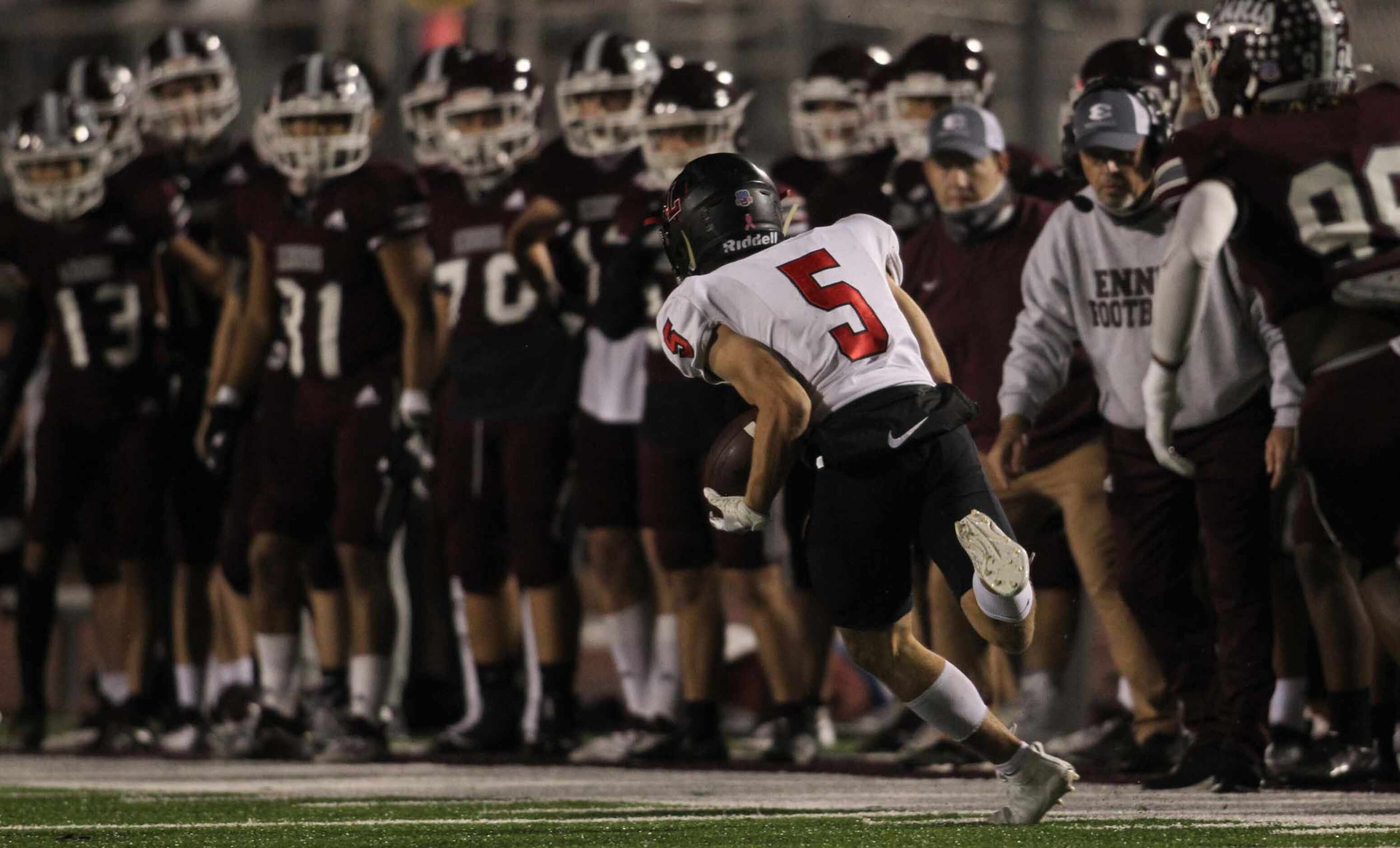 Frisco Liberty running back Will Ashmore (5) scampers for a first down in front of the Ennis...