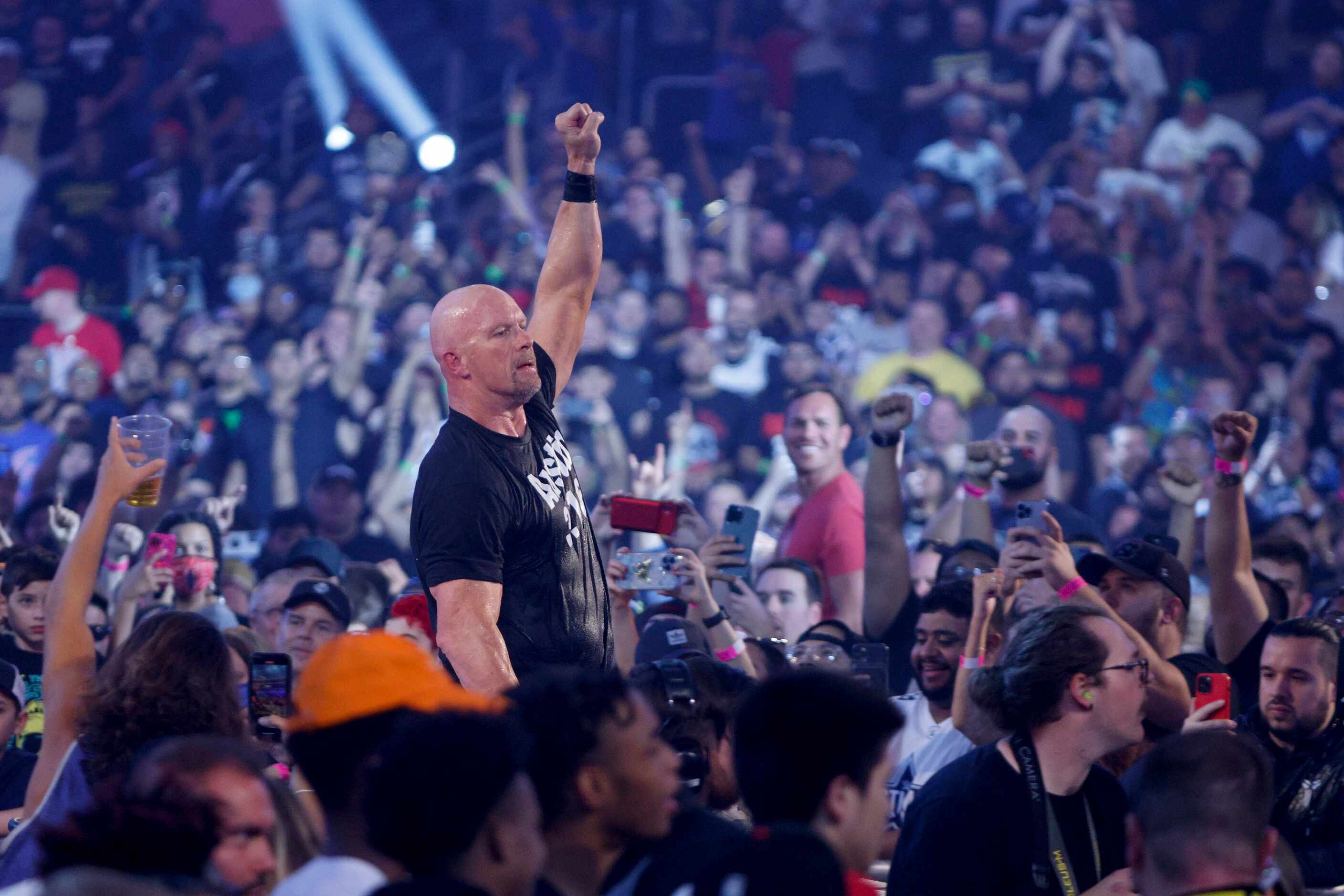“Stone Cold” Steve Austin celebrates after defeating Kevin Owens in a match at WrestleMania...