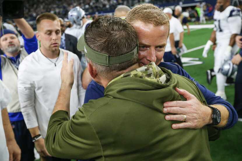Dallas Cowboys head coach Jason Garrett embraces New Orleans Saints head coach Sean Payton...