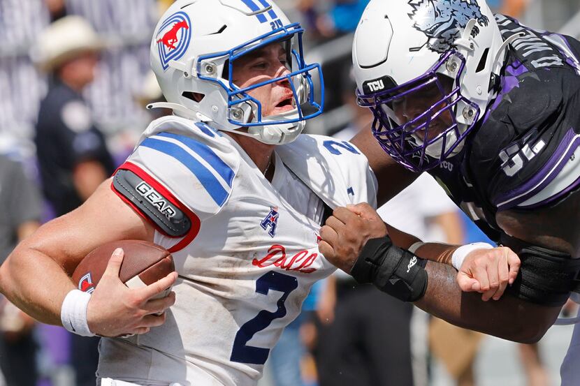 Southern Methodist Mustangs quarterback Preston Stone (2) is sacked by TCU Horned Frogs...