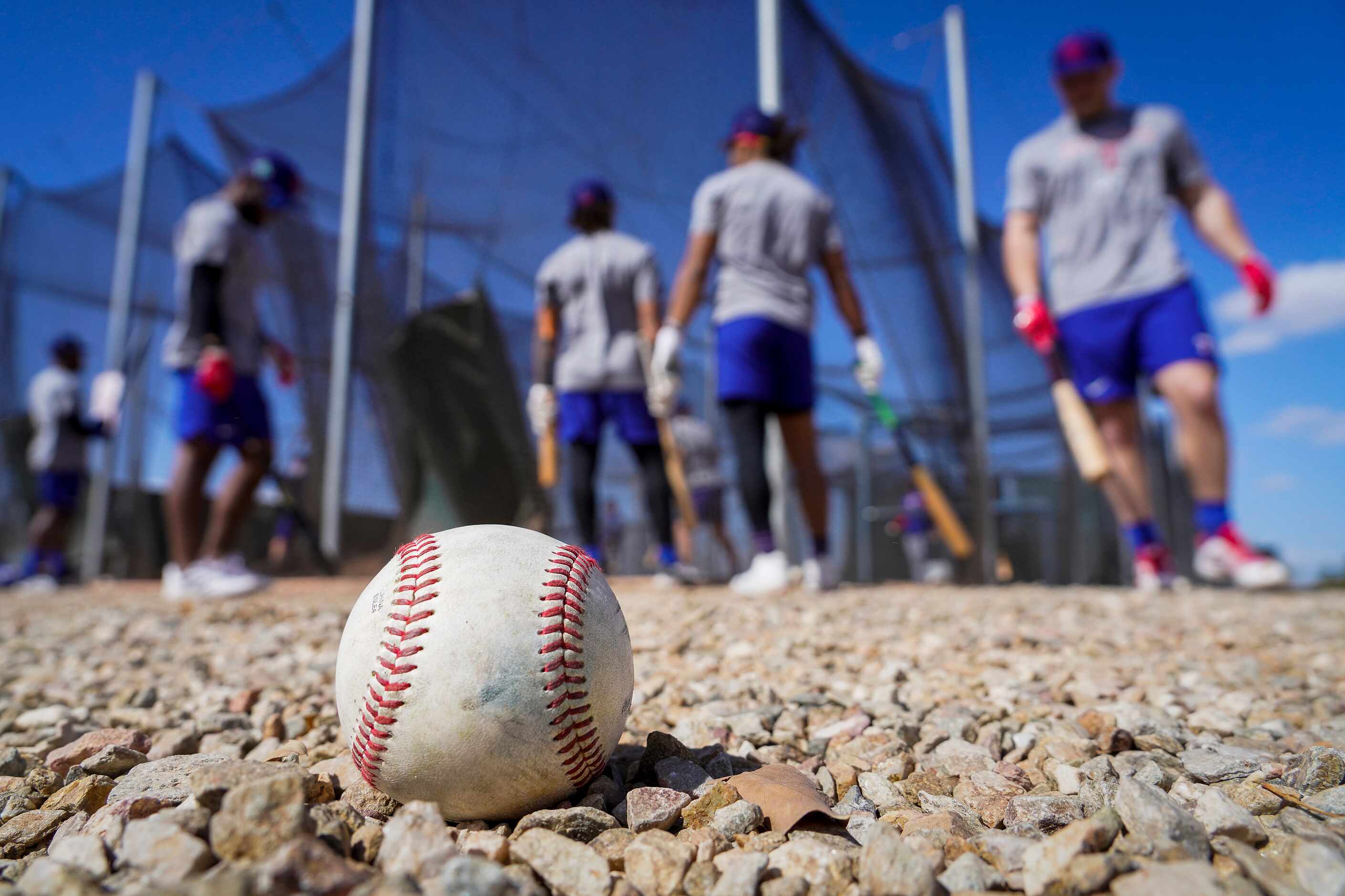 Players rotate into a batting cage during the Texas Rangers first minor league spring...