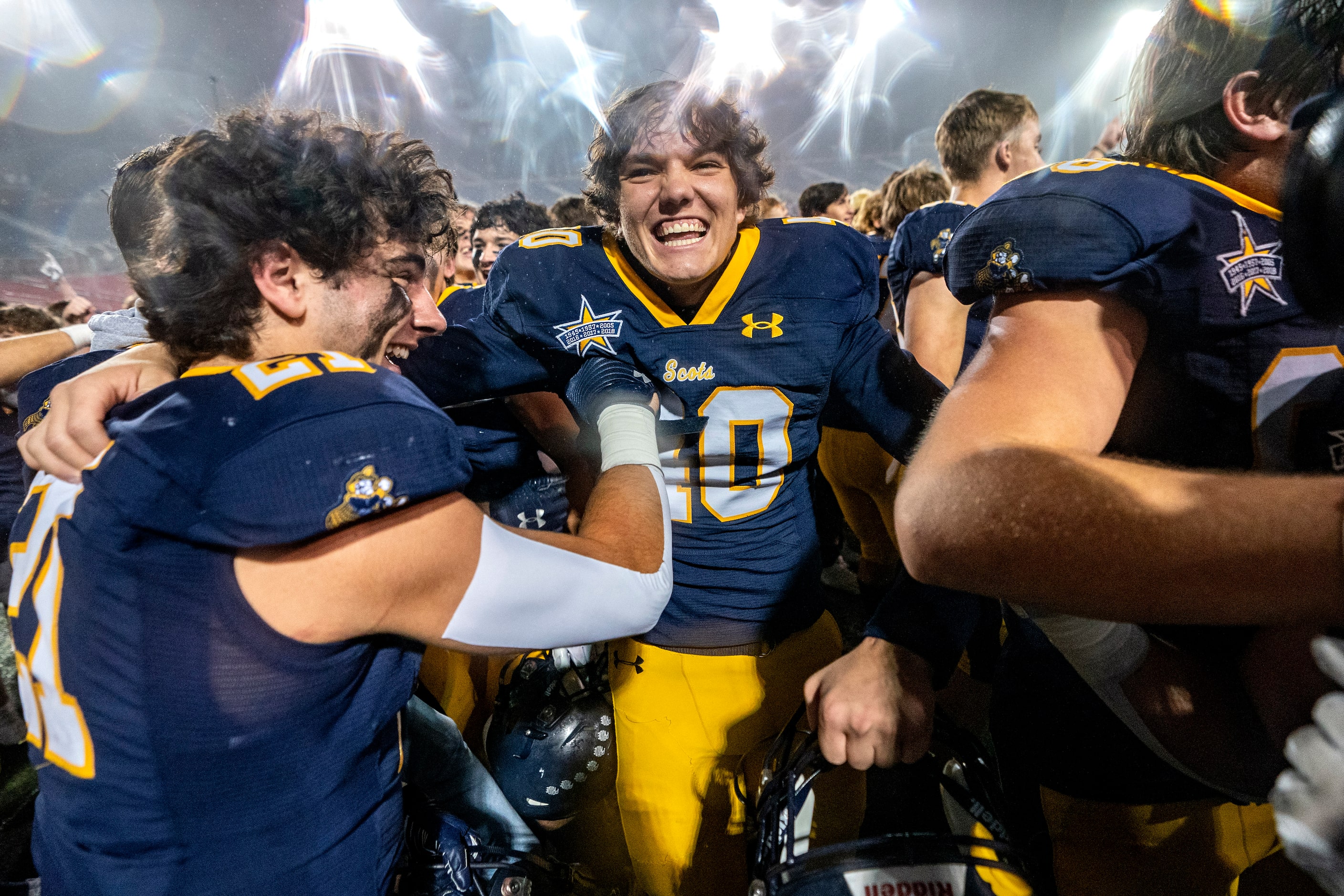 Highland Park senior kicker Nicholas Rigas (40) is congratulated by senior running back...