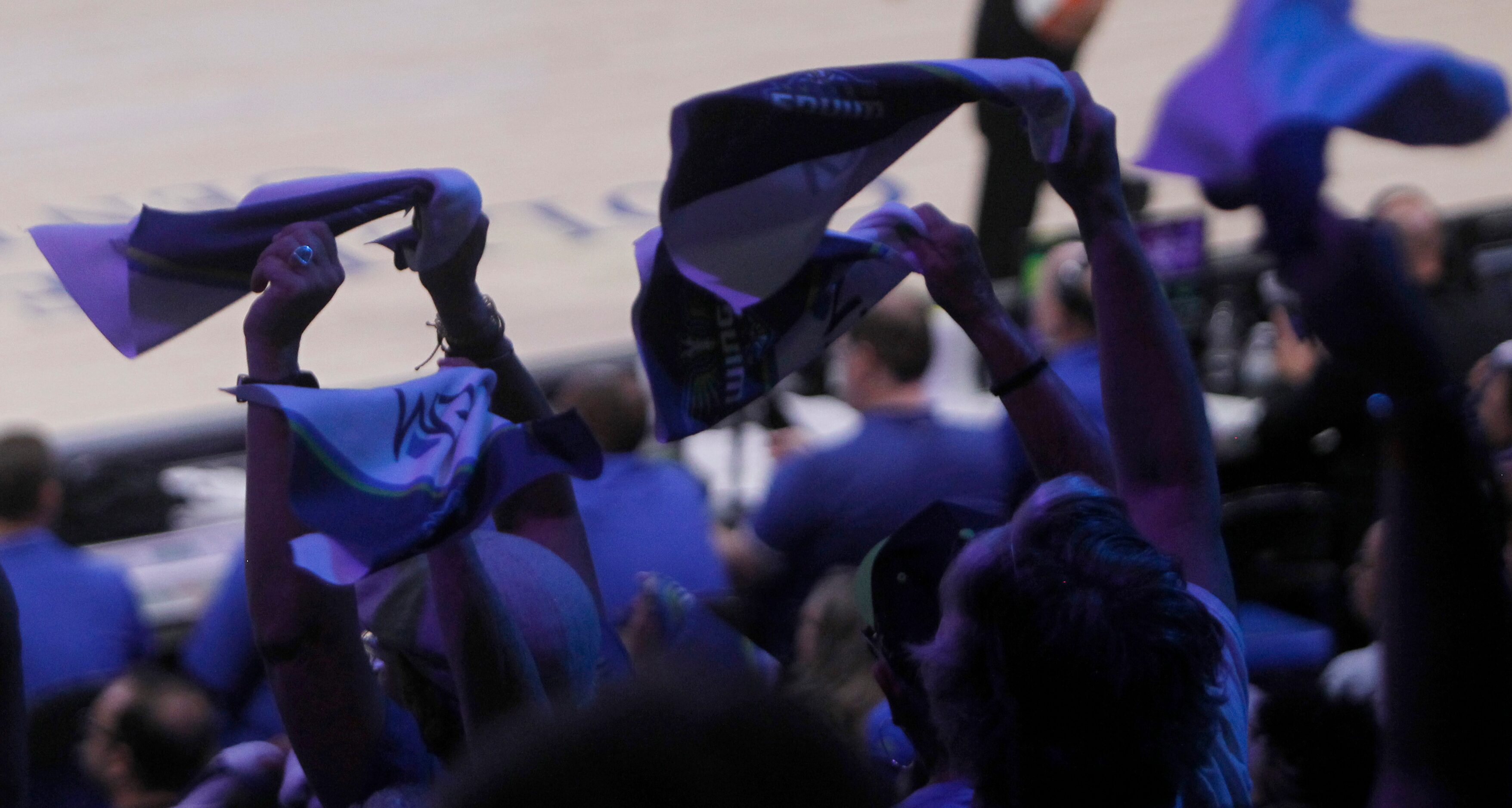 Dallas Wings show their support by waving towels during a timeout during the final minute of...