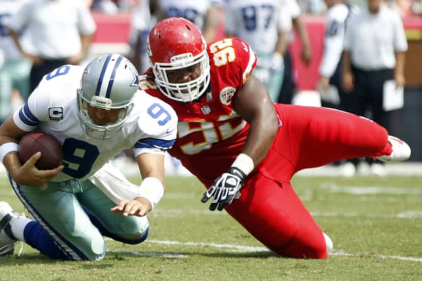 Dallas Cowboys quarterback Tony Romo (9) is sacked by Kansas City Chiefs nose tackle Dontari...