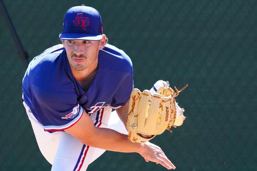 Texas Rangers pitcher Cole Winn throws in the bullpen during a spring training workout at...