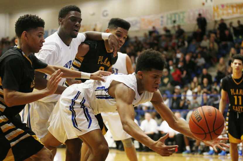 Plano West guard Chris Giles (4) attempts to recover a loose ball in the second half during...