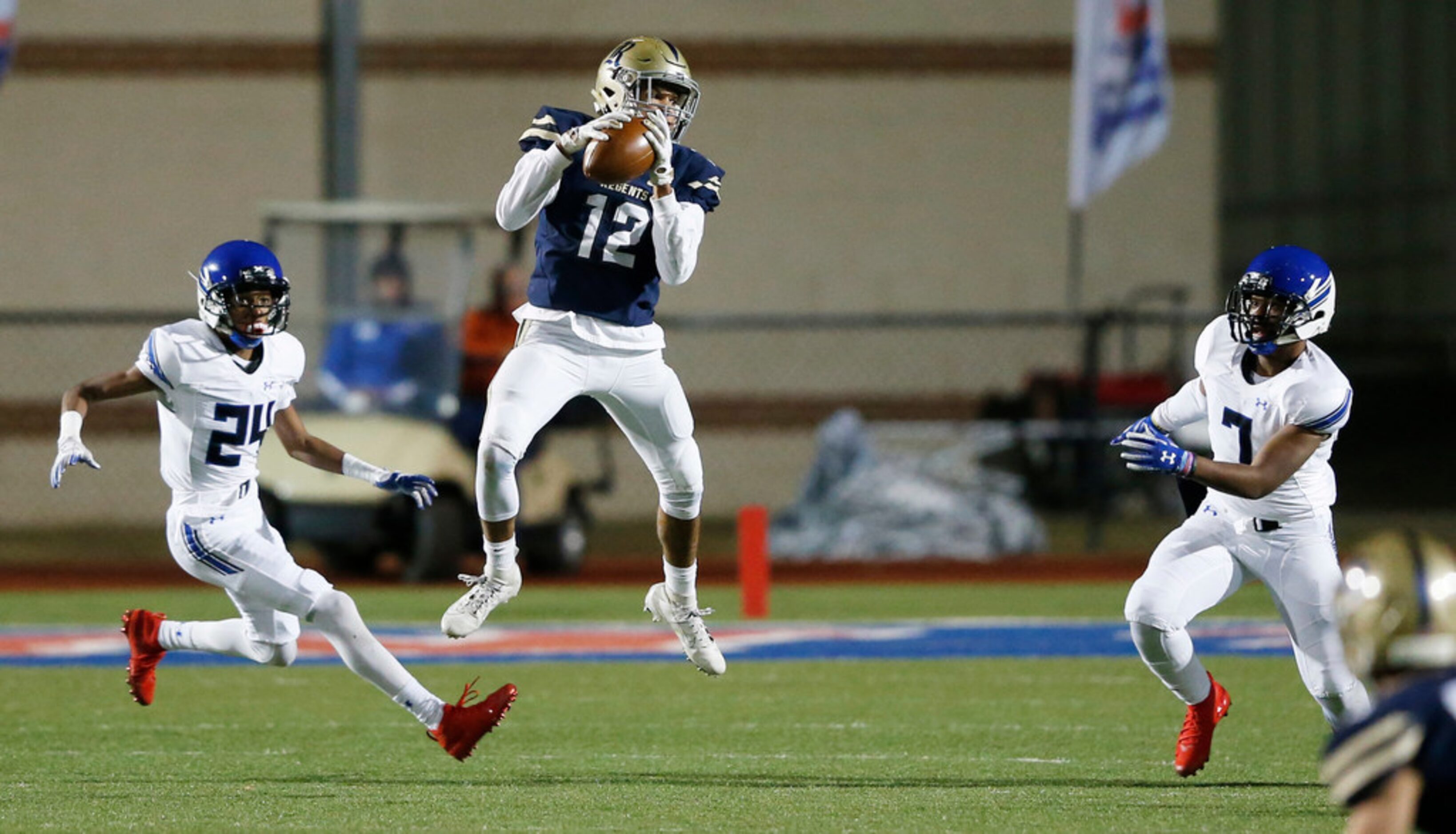 Austin Regents Aidan McCormick (12) catches a pass in between Trinity Christian's Tony...