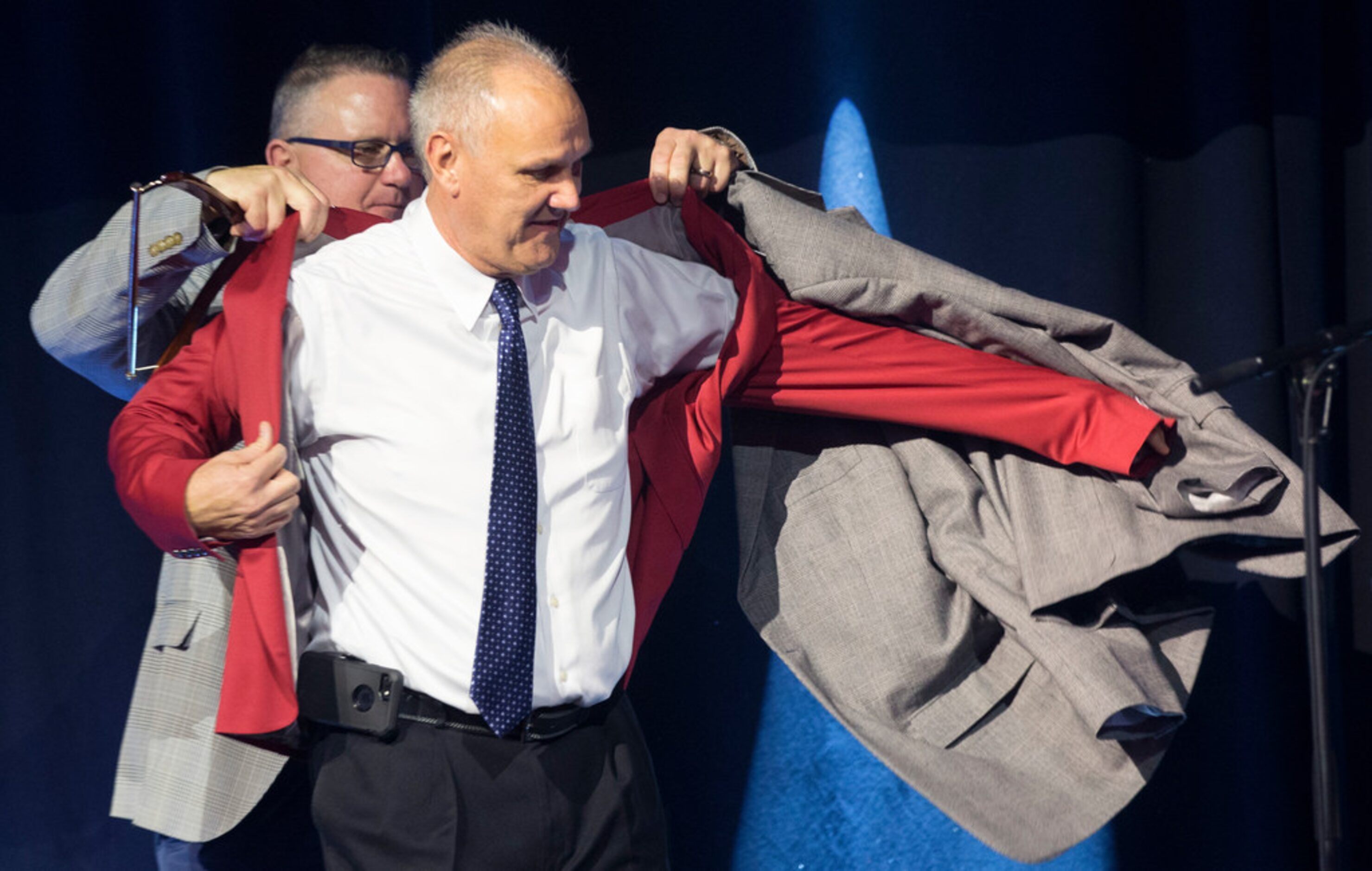 Kip Fagg, Amateur scouting senior director, left, helps Mike Grouse, 2018 Red Jacket Scout...